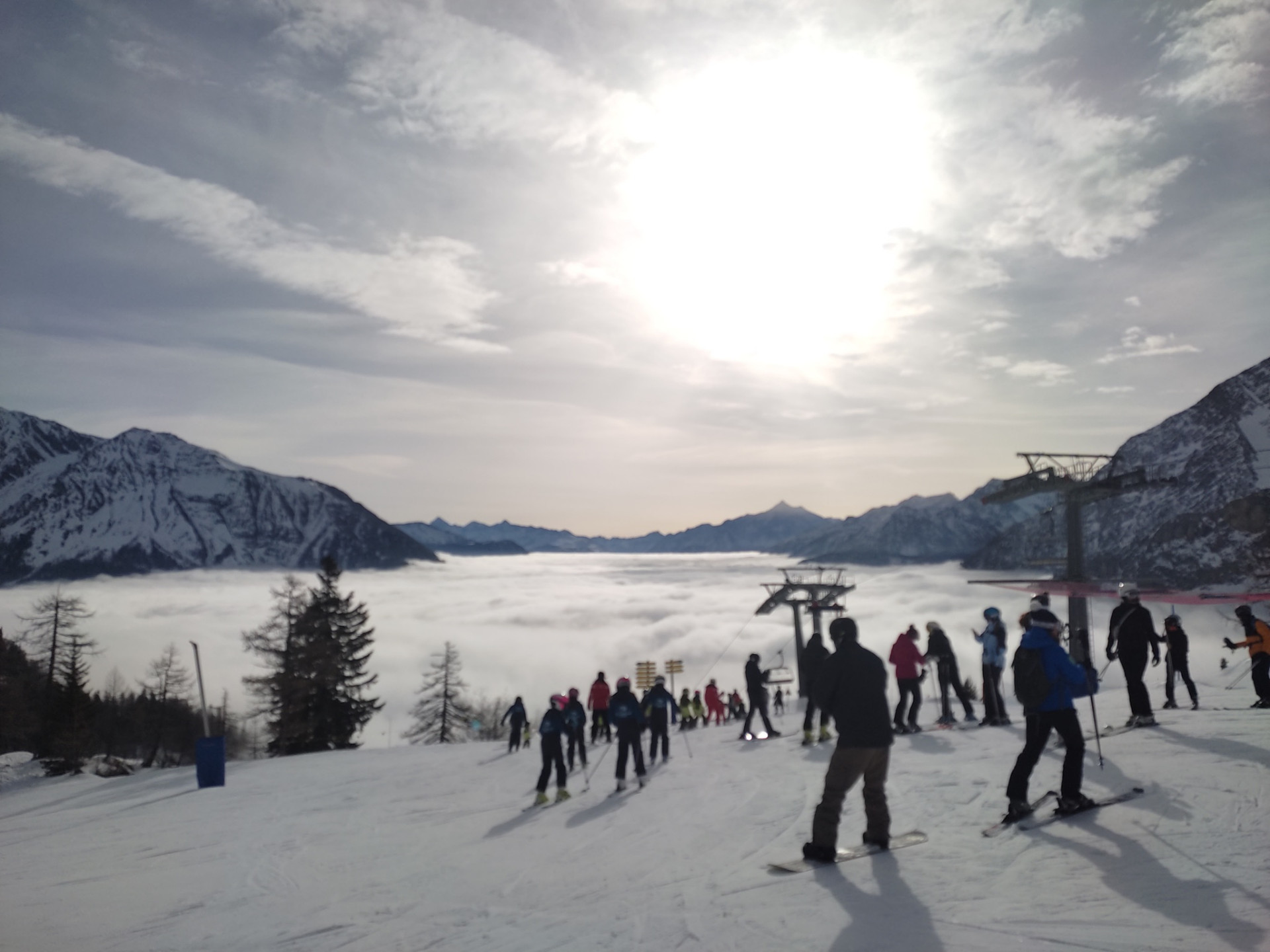 Skiers above the clouds at Courmayeur